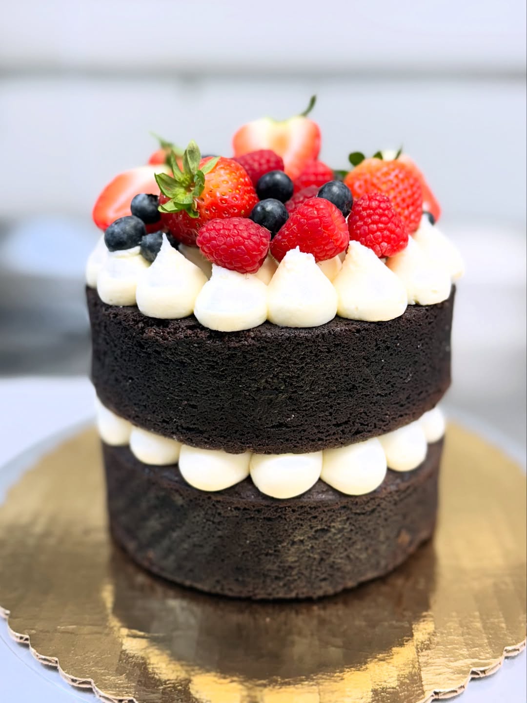 Berry-topped chocolate celebration cake